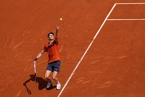 Jannik Sinner serves against Grigor Dimitrov